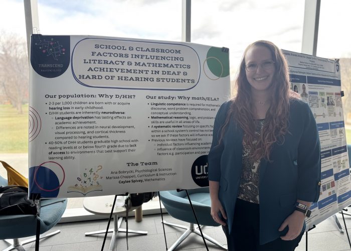 Caylee Caylee posing with her poster